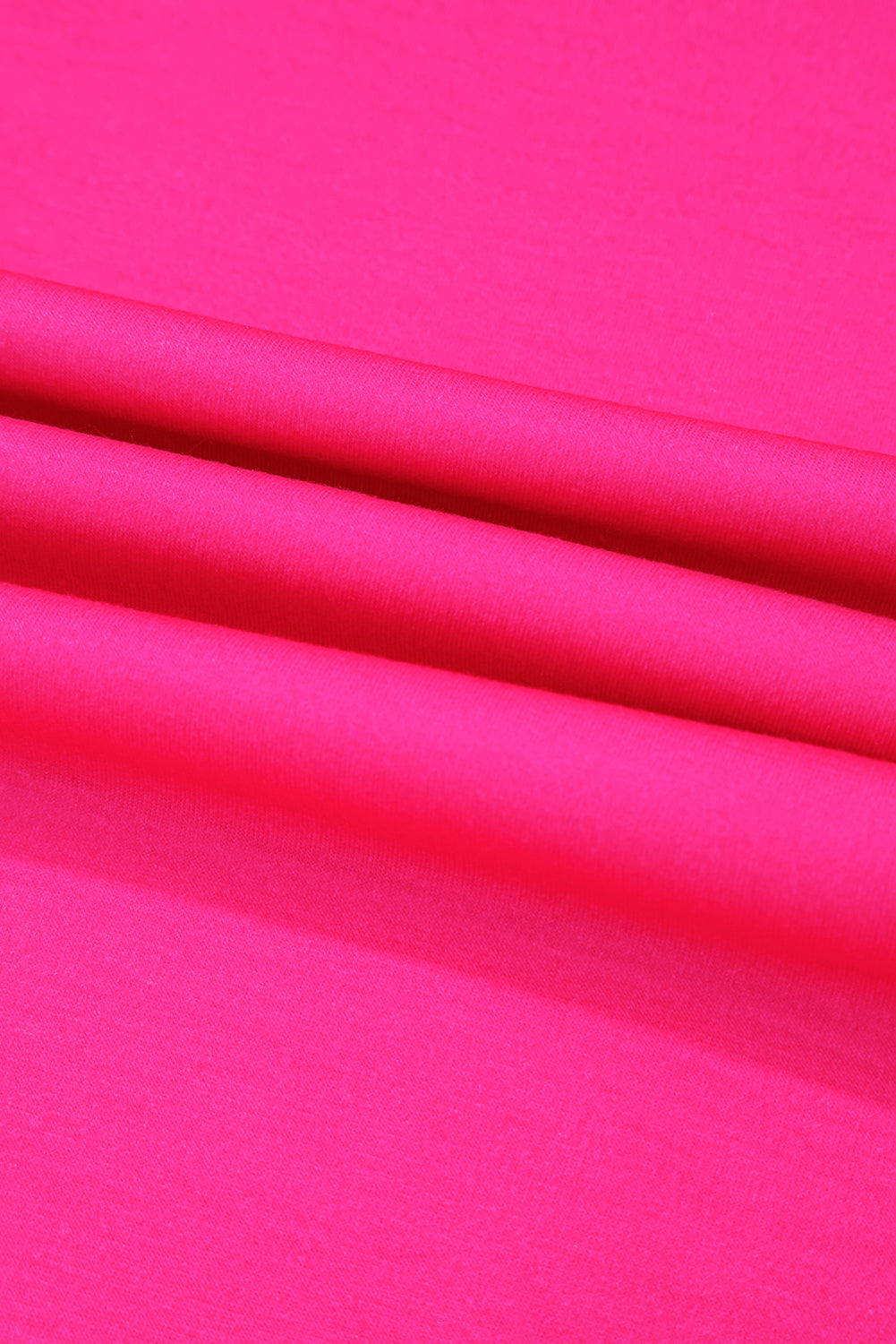 Bright pink fabric texture showcases vibrant polyester and elastane blend.