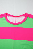 Pink and green colorblock crew neck top with vibrant striped design and drop shoulders, enhancing wardrobe versatility and style.