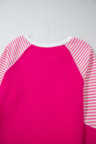 Back view of PROMISE YOU Top by Vivian-Lu featuring pink body and striped raglan sleeves for a sporty look.