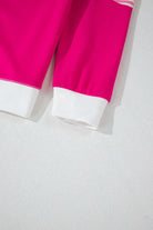 Close-up of PROMISE YOU Top by Vivian-Lu, showcasing the vibrant pink color and white cuffs of the sporty design.