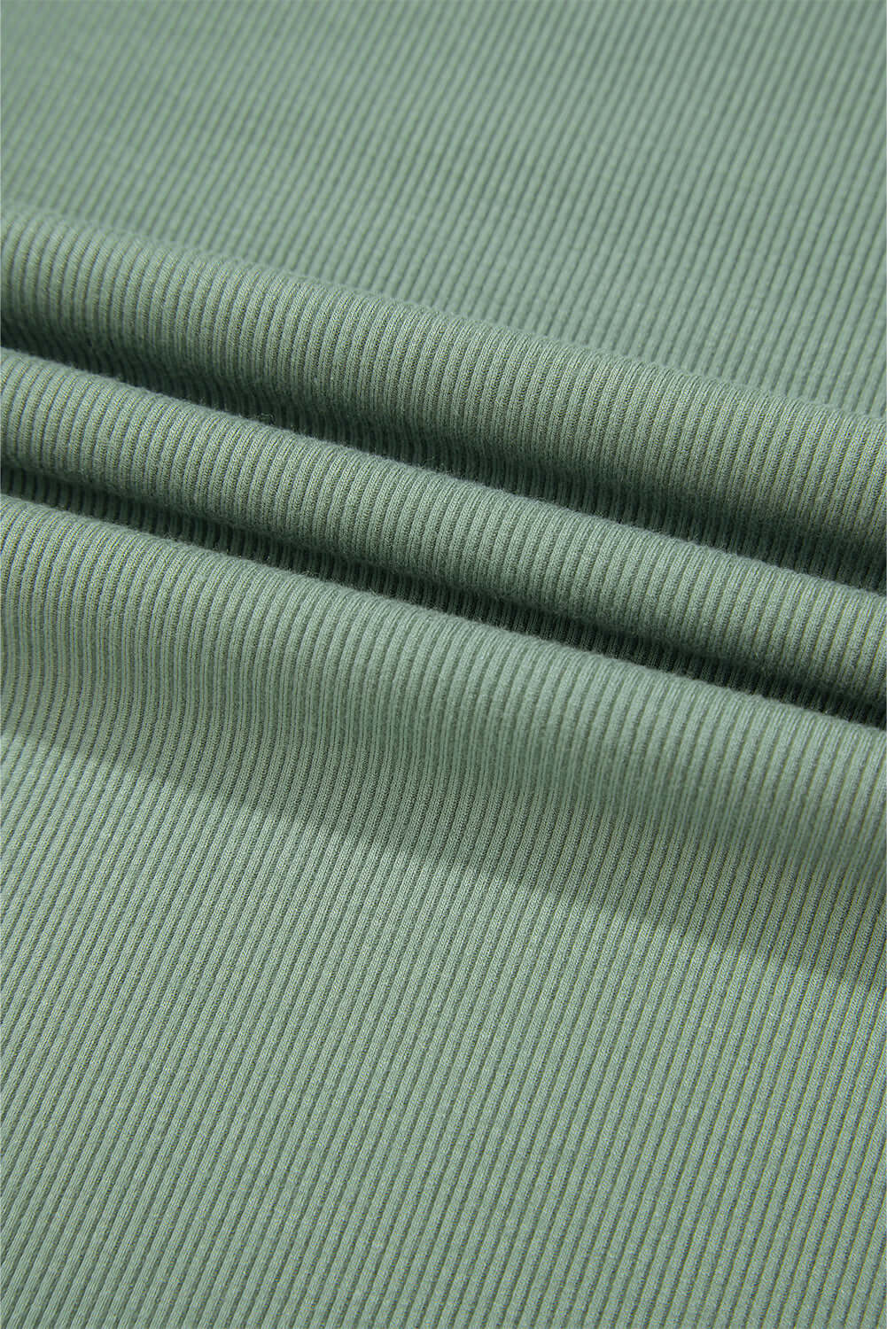 Soft ribbed fabric in a soothing green shade, showcasing texture for the Whispering Willow top.