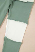 close-up of the ribbed detailing and color block design on the Whispering Willow top in green and white