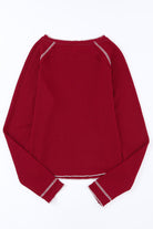 Red waffle knit KICKOFF TIME TOP with raglan sleeves, perfect for showcasing team spirit on game day.