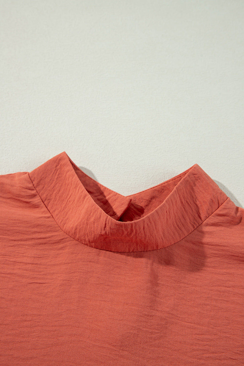 Rust-colored Autumn Sunset Top with textured fabric and a chic neckline.