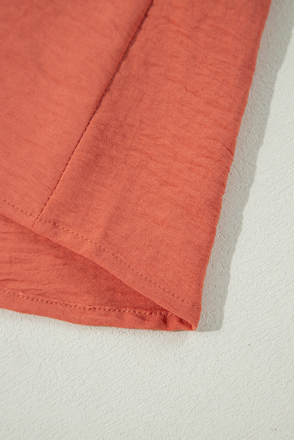 Close-up of the Autumn Sunset Top in rich rust color, showcasing soft polyester fabric texture and elegant seam details.