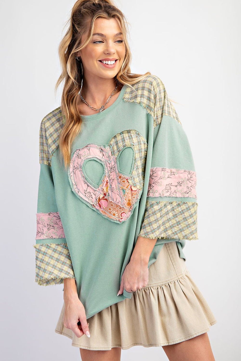 Mint Peacekeeper top with plaid and floral patches, peace sign heart graphic, wide long sleeves, casual oversized look.