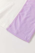 Close-up of the color-block design featuring white and lavender fabric of the Enchanted Aura Top.