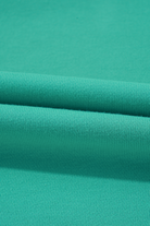 Close-up of teal green fabric texture for Malibu Marina top showcasing quality material and vibrant color.