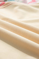 Close-up of soft, cream fabric showcasing smooth folds, ideal for elegant clothing designs.