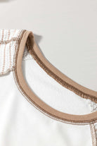 Close-up of A Fine Line Top neckline featuring white fabric and tan striped detail for a stylish and casual look.