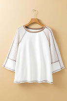 A Fine Line Top in white and tan featuring patchwork design and striped raglan sleeves, perfect for casual occasions.