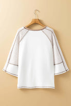 Back view of A Fine Line Top with patchwork design and striped raglan sleeves in white and tan.