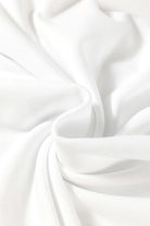 Close-up of soft, white fabric showcasing smooth texture, ideal for a stylish Fine Line Top.