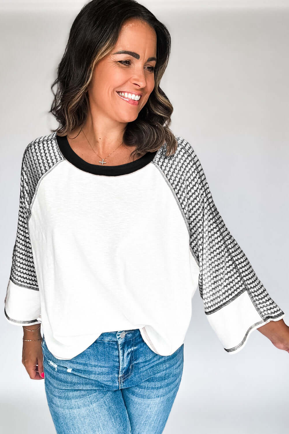 A Fine Line Top with patchwork design and striped sleeves, worn casually for a friendly and stylish look.