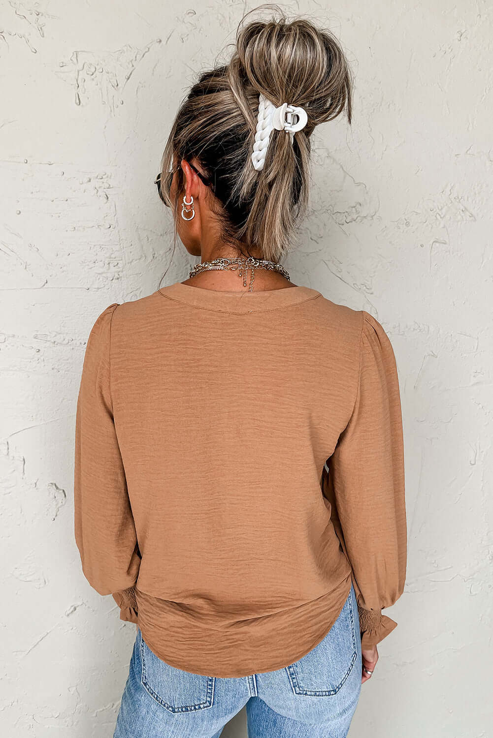 Back view of the BEAUTIFUL YOU Top by Vivian-Lu, featuring shirred cuffs and a sleek design in a warm taupe color.