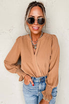 Woman wearing BEAUTIFUL YOU Top by Vivian-Lu, featuring V neck notch and shirred cuffs, styled with sunglasses and jeans.