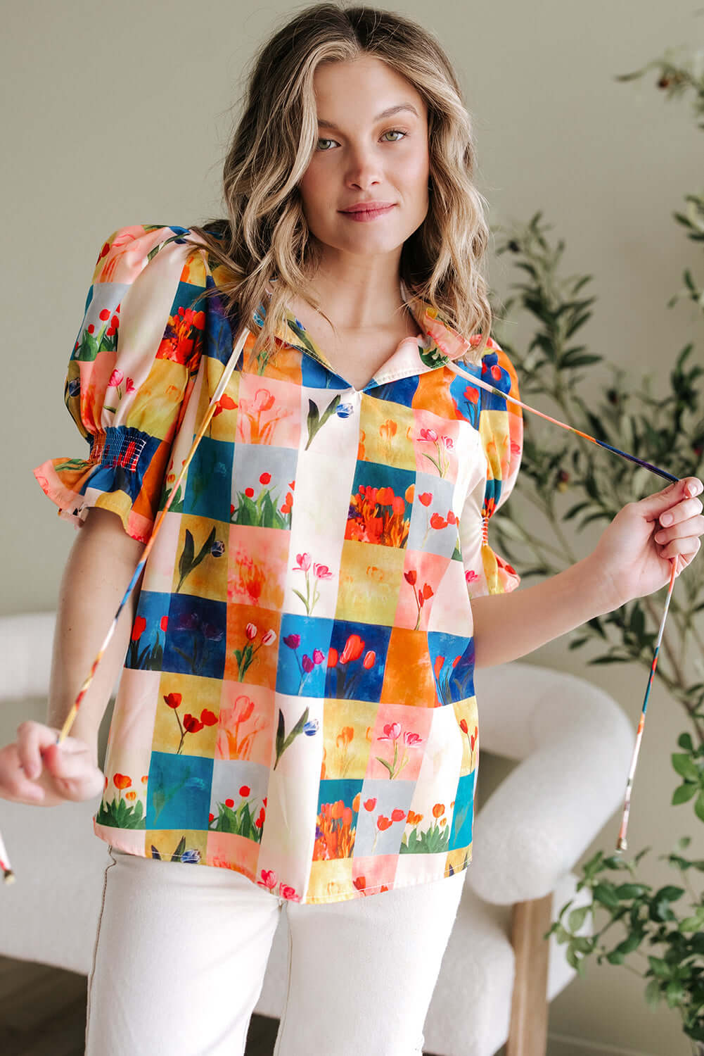 Vibrant floral checker print blouse featuring puff sleeves, perfect for a stylish garden look.