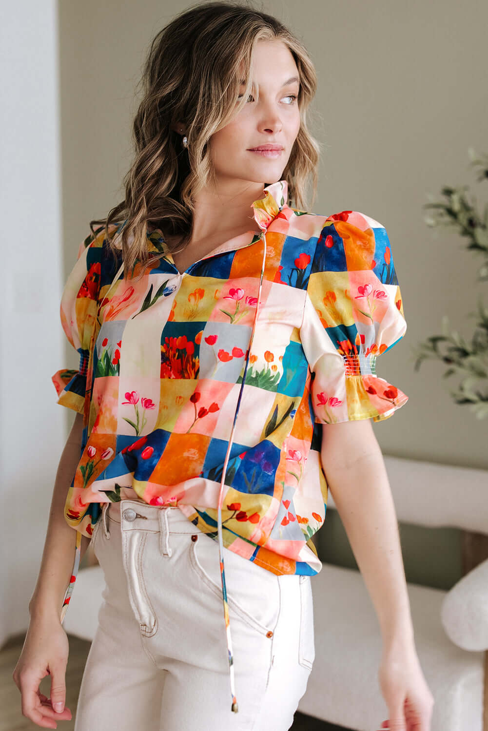 Vibrant floral checkerboard blouse showcasing artful colors, perfect for a stylish garden-inspired look.