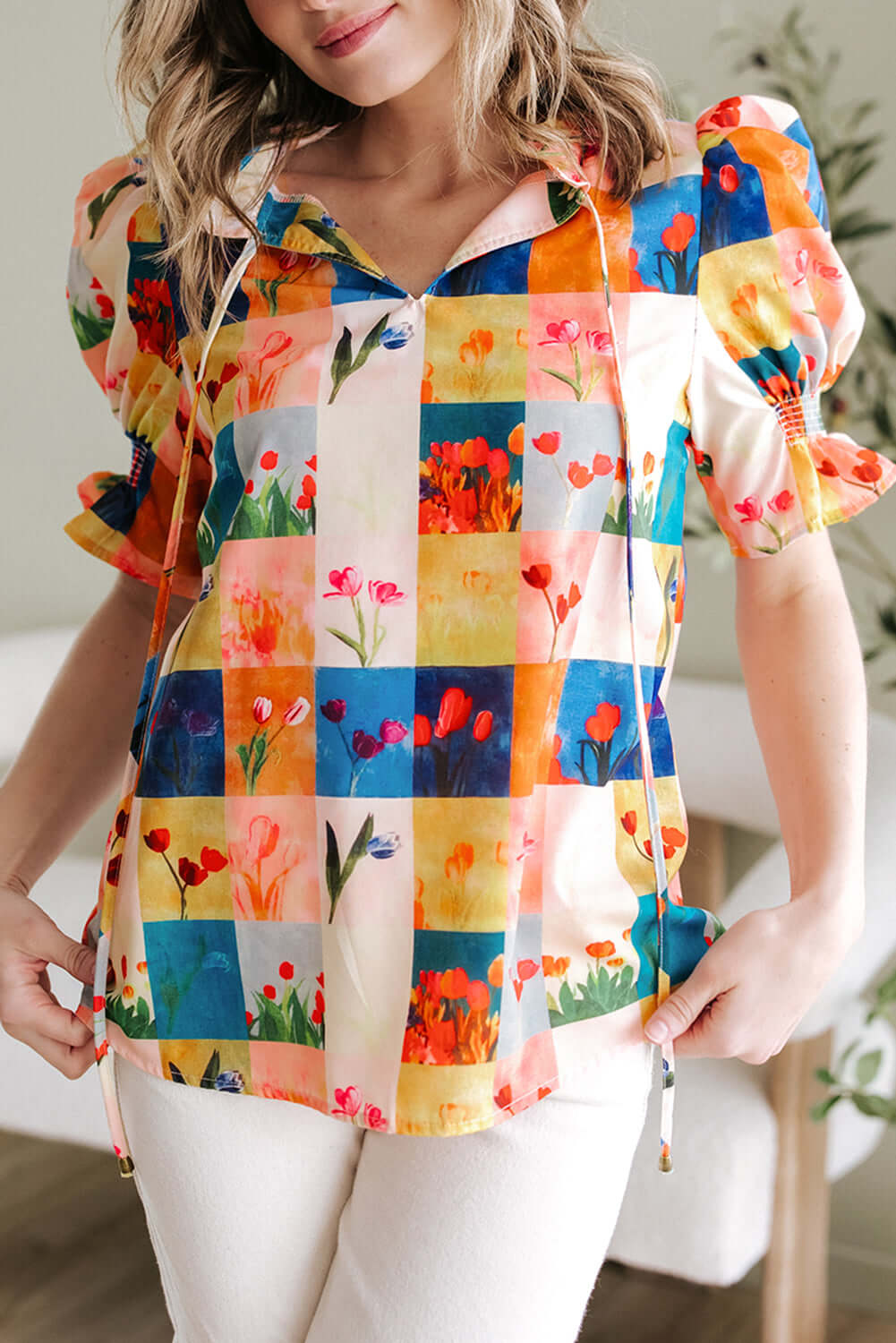 Vibrant floral checker print blouse with puff sleeves, perfect for adding style to any outfit.