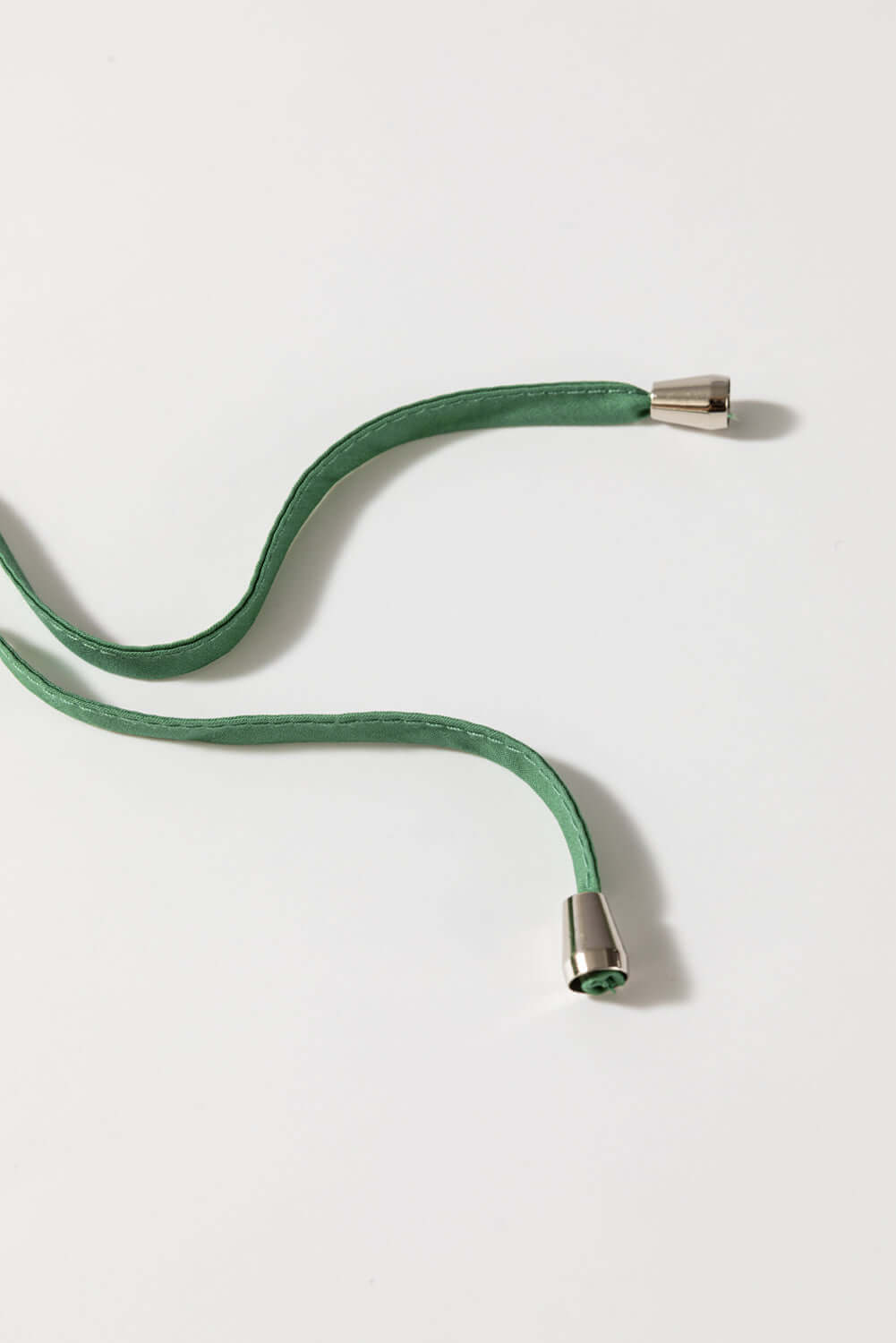 Misty green cord with metal ends, perfect for stylish accessories or DIY projects.
