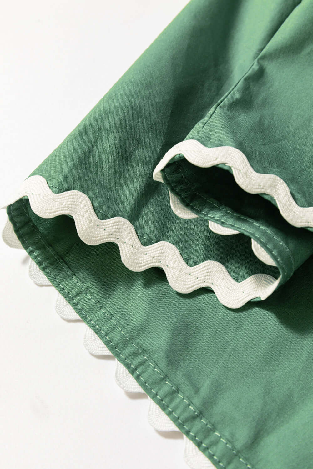 Close-up of Garden Gala Top showcasing misty green fabric with playful ivory ric rac trim detail.