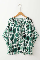 Stylish women's Enchanted Valley blouse with 3/4 ruffled sleeves and a playful spotted design.