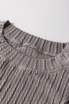 Close-up of the textured gray Sound Wave top showcasing cable-knit fabric and ruffle sleeve design.