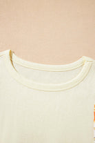 Close-up of the round neck and fabric texture of the Sun Dance top with floral prints.