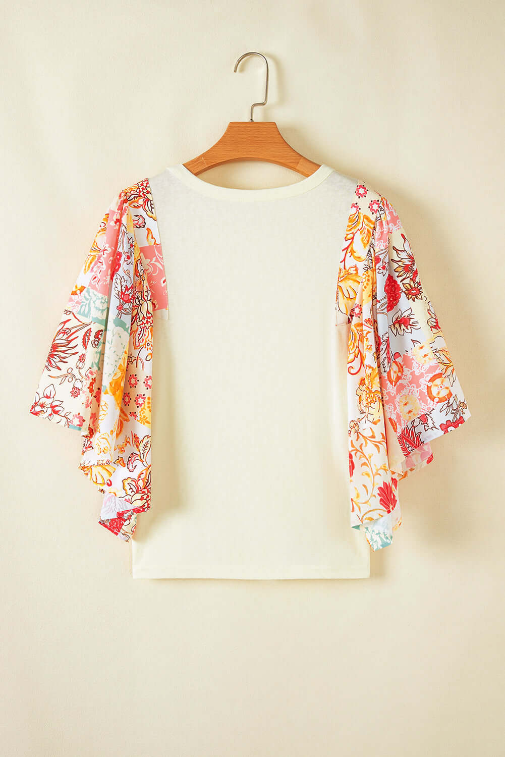 Sun Dance top featuring floral print batwing sleeves and a relaxed fit, perfect for bohemian style.