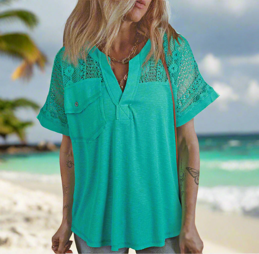 Aqua Allure top featuring lace sleeves and a relaxed silhouette, perfect for casual elegance by the beach.