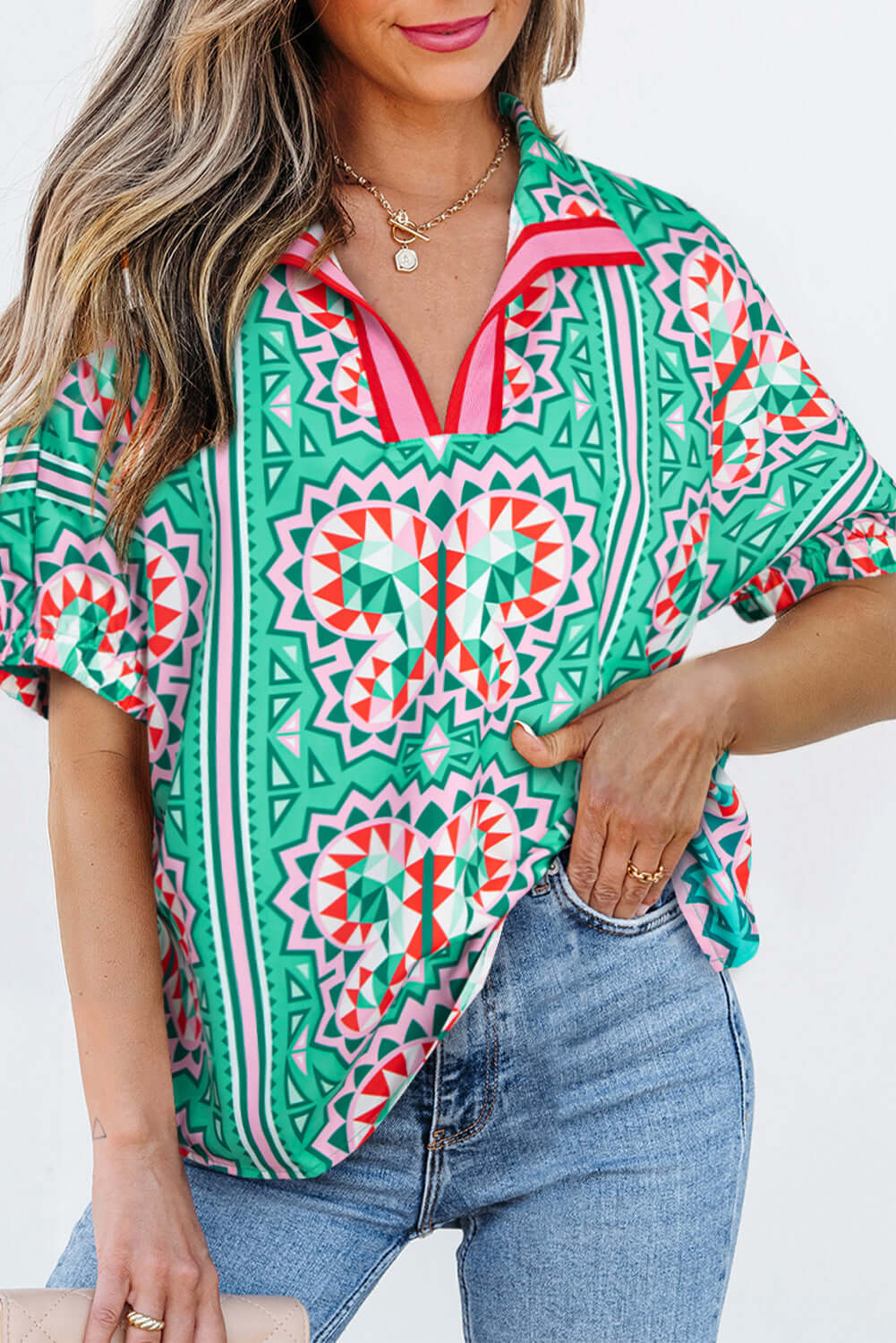 Abstract Energy Top in sea green with colorful geometric patterns and a chic V-neckline.