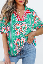 Abstract Energy Top in sea green with colorful geometric patterns and a chic V-neckline.