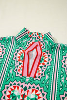 Sea green abstract print blouse with a striped collar and V-neckline in bold geometric patterns.