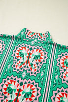 Abstract Energy Top featuring vibrant sea green, coral, and blush geometric print and striped collar.
