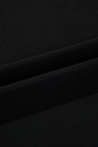 Close-up of luxurious black fabric, showcasing soft texture and smooth folds for stylish apparel.