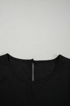 Close-up of the round neck of the Fringe Benefits black blouse featuring a back zipper detail.