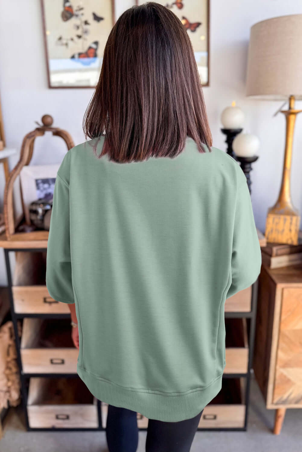 Back view of the Flowery Theory Top in sea green, showcasing its loose fit and comfy style.