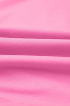 Close-up of soft, taffy pink fabric showcasing smooth texture, perfect for casual wear like the Flower Theory Top.