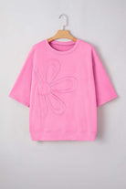 Flower Theory Top in taffy pink with oversized floral design and relaxed fit for casual style.