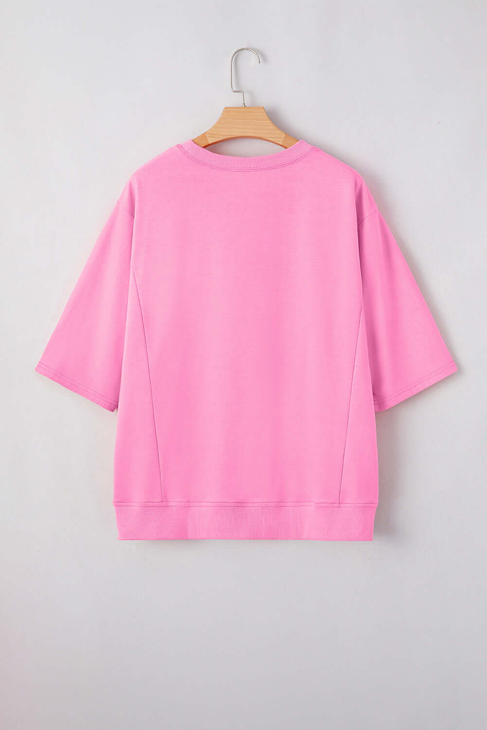 Back view of Flower Theory Top in taffy pink, featuring a relaxed fit with loose half sleeves.
