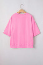 Back view of Flower Theory Top in taffy pink, featuring a relaxed fit with loose half sleeves.