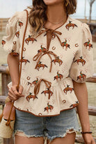 Rodeo Romance Top with cowboy print, puff sleeves, and bow detail, perfect for Western fashion lovers.