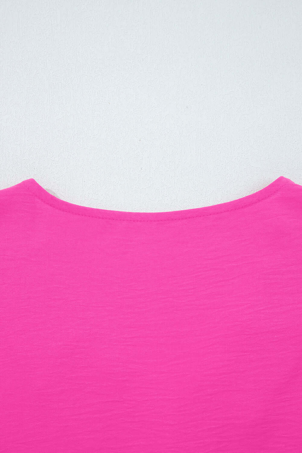 Back view of the GRACEFUL GLOW TOP (bright pink) showing the elegant neckline and vibrant color.