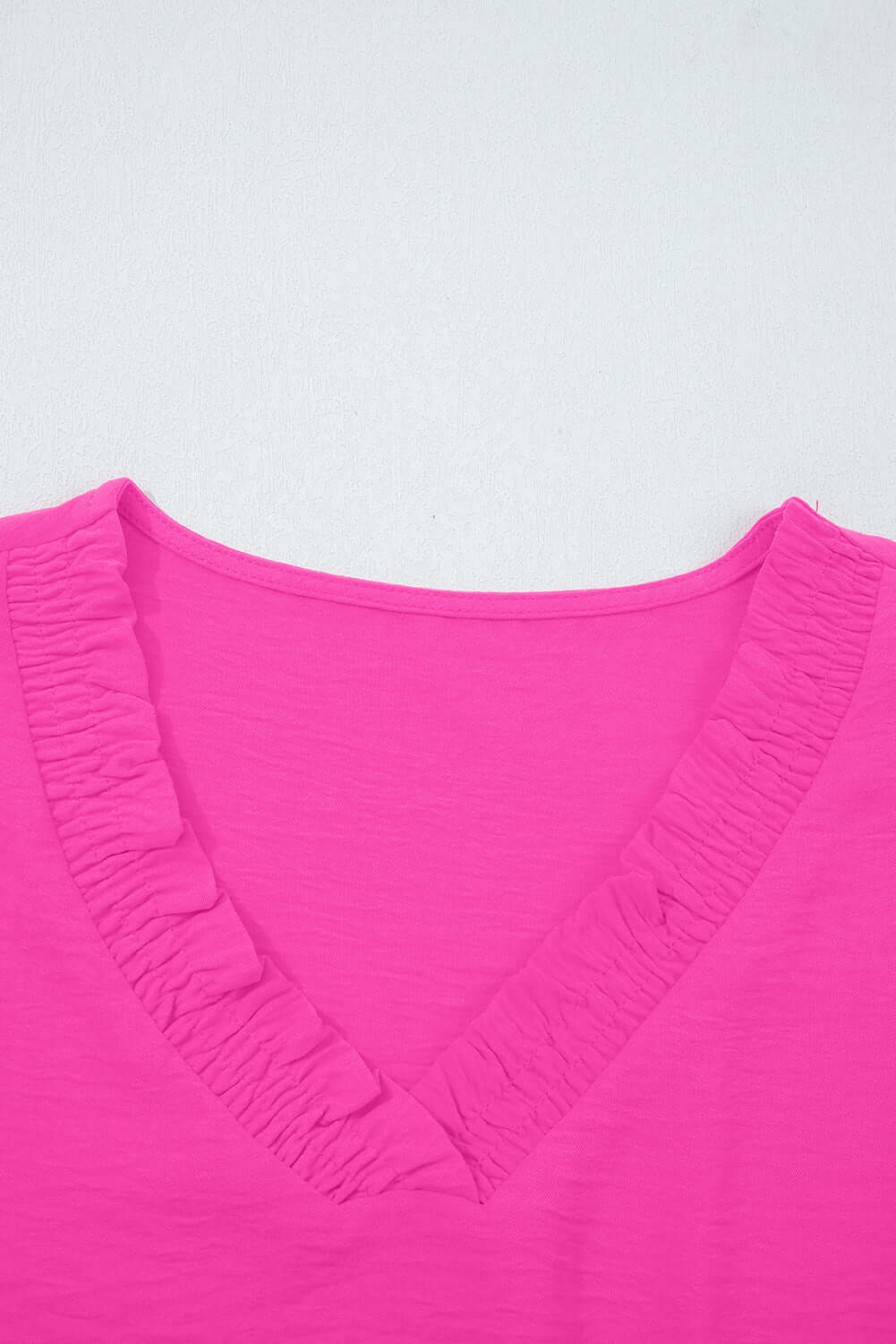 GRACEFUL GLOW TOP (bright pink) showing elegant frilled V-neckline and vibrant color.
