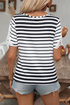Back view of Crisscross Charisma Top featuring black stripes and lace-accent short sleeves.