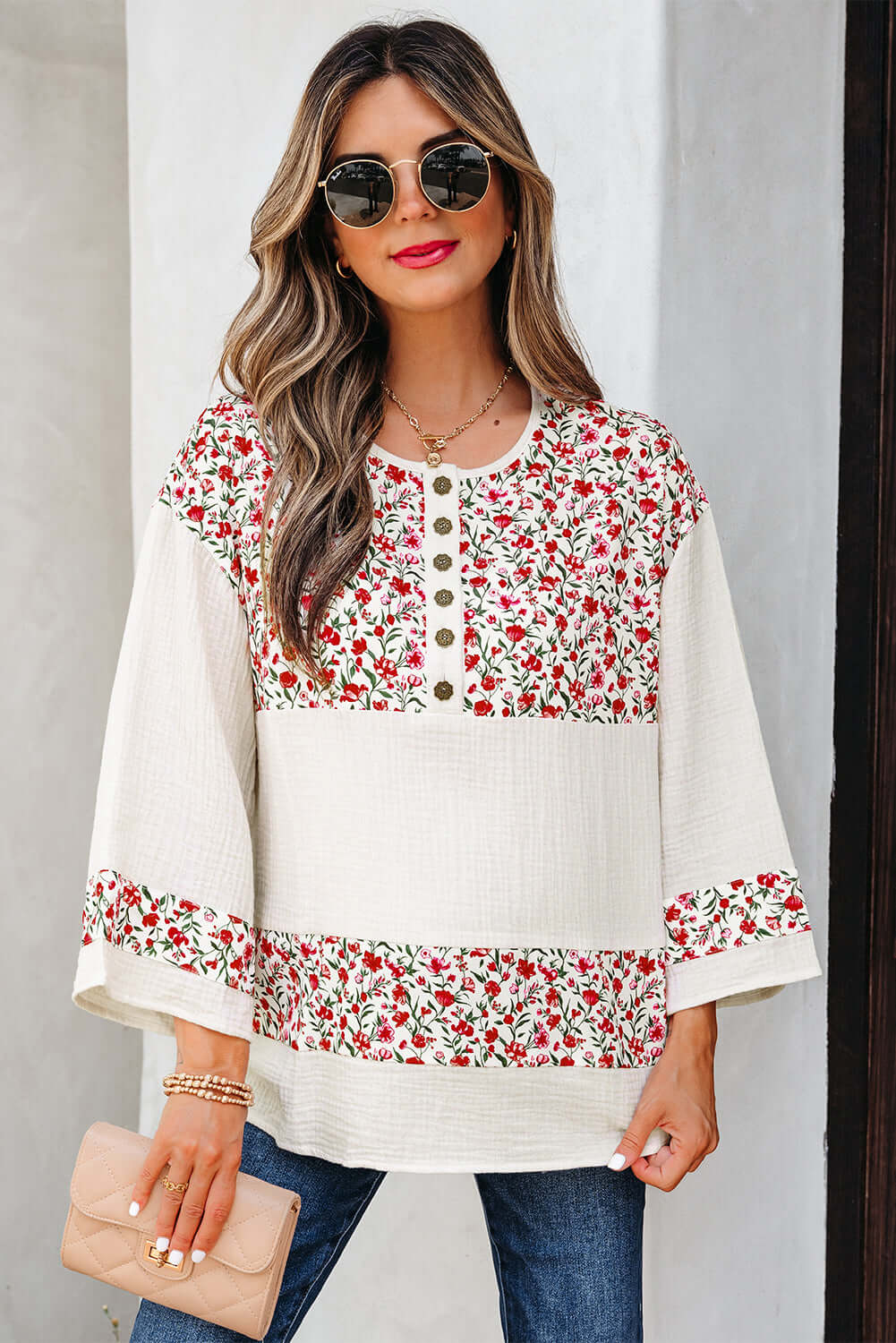 Crossroads Cutie blouse with floral design, 3/4 sleeves, and Henley button neckline against a neutral background.