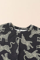 Close-up of the Cant Be Tamed top featuring a bold cheetah print pattern on a black background.