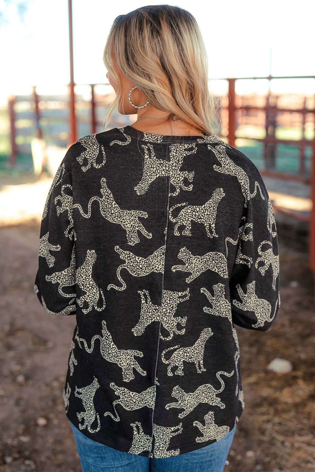 Back view of the Cant Be Tamed long-sleeved top featuring a lively cheetah print, perfect for stylish outfits.