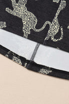 Close-up of the Cant Be Tamed long-sleeved top featuring a bold cheetah print design and soft fabric details.