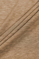 Close-up of soft, textured beige fabric with pleats, perfect for elegant fashion designs.